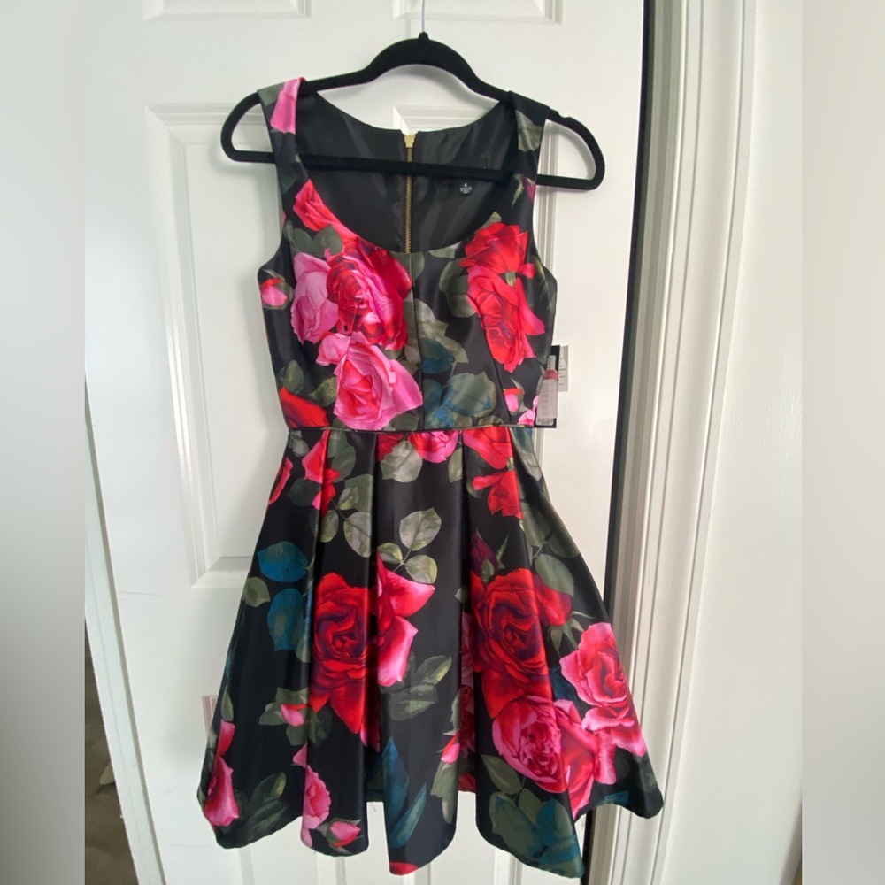 Never been worn, size 4 Betsy and Adam dress. Rose detail on black background.